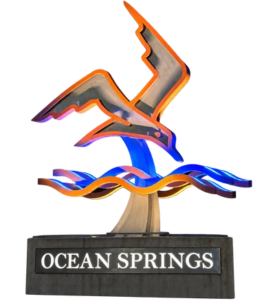 Ocean Springs gateway sculpture — a seagull over waves on the stone Ocean Springs base